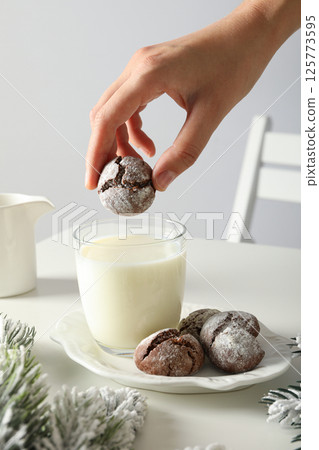 Delicious Grinkle cookies in a plate, with milk, on a light background. 125773595