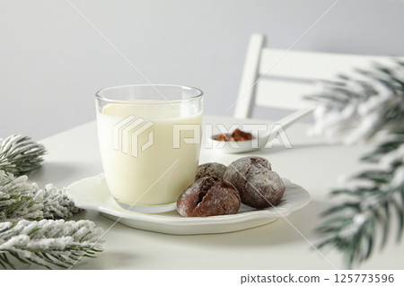 Delicious Grinkle cookies in a plate, with milk, on a light background. Delicious Grinkle cookies in a plate, with milk, on a light background. 125773596