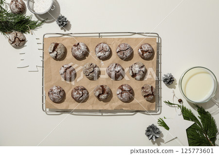 Appetizing crinkle cookies, on parchment, on a dark background. Appetizing crinkle cookies, on parchment, on a dark background. 125773601
