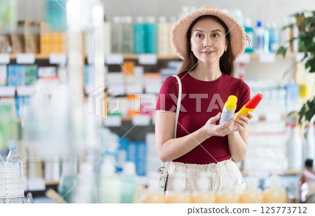 Woman choosing a repellent at the pharmacy Woman choosing a repellent at the pharmacy 125773712