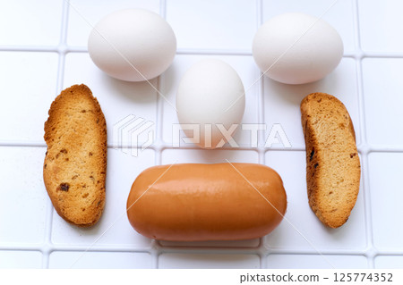 Simple delicious breakfast. Sausage, toasted bread, three eggs Simple delicious breakfast. Sausage, toasted bread, three eggs 125774352