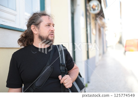Tourist walking in a narrow street exploring a new city 125774549