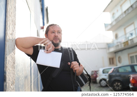 Tourist looking for directions in european city during summer vacation 125774564