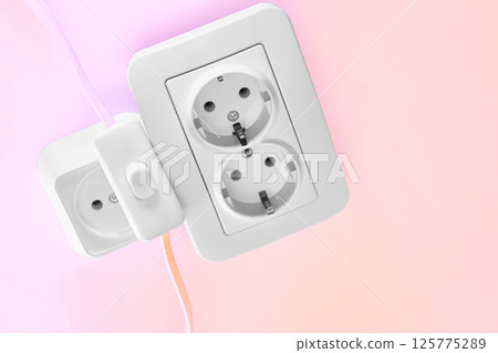 Electrical sockets for connecting devices and a switch on pink Electrical sockets for connecting devices and a switch on pink 125775289