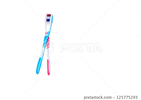 Dance of pink blue toothbrush on white Dance of pink blue toothbrush on white 125775293