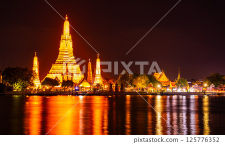 Wat Arun Ratchawararam Ratchawaramahawihan or Wat Arun, Buddhist temple along the Chao Phraya river at night sky in Bangkok, Thailand 125776352