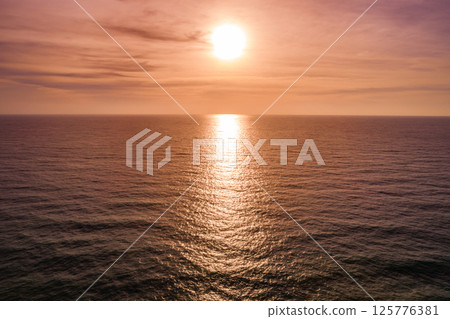 Aerial view sunset sky,Nature beautiful light sunset or sunrise over sea surface,Colorful sunset sky with clouds and waves in the ocean,Wide angle sea background 125776381