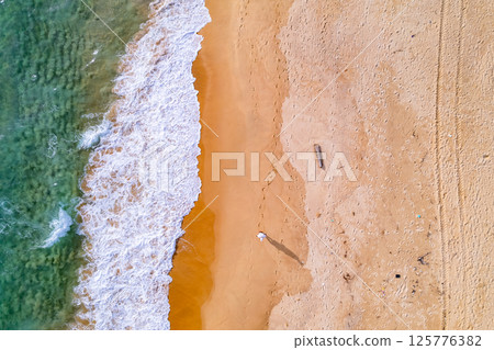 Amazing Top view sea beach landscape background,Summer sea waves crashing on sandy shore seascape background,High angle view ocean nature background 125776382