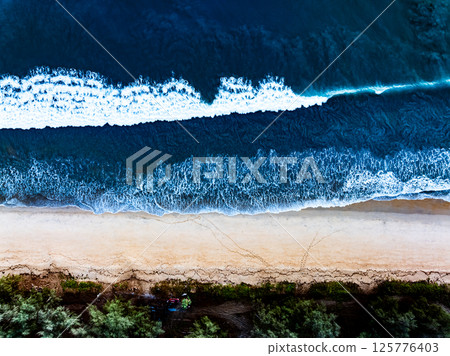 Top view Dark waves crashing on sandy shore beach background,Amazing waves sea nature background Top view Dark waves crashing on sandy shore beach background,Amazing waves sea nature background 125776403