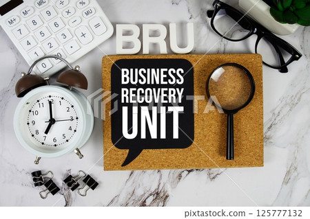 BRU - Business Recovery Unit acronym with calculator, alarm clock and magnifying glass, Business concept background BRU - Business Recovery Unit acronym with calculator, alarm clock and magnifying glass, Business concept background 125777132