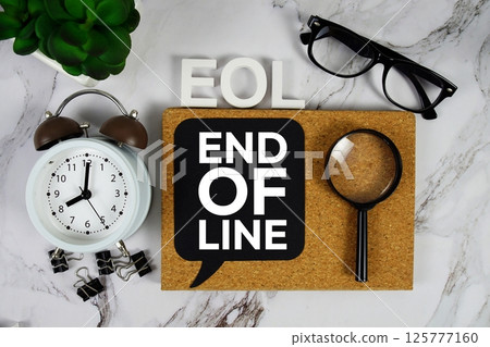 EOL - End of Line acronym with alarm clock and magnifying glass, business concept background 125777160