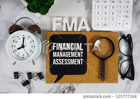 FMA - Financial Management Assessment acronym with calculator, alarm clock and magnifying glass, Business and Financial concept background 125777168