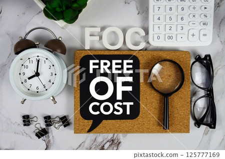 FOC - Free Of Cost acronym with calculator, alarm clock and magnifying glass, Business and Financial concept background FOC - Free Of Cost acronym with calculator, alarm clock and magnifying glass, Business and Financial concept background 125777169