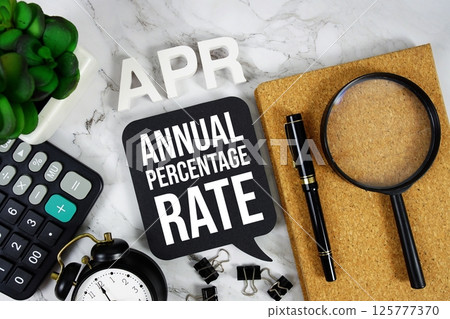 APR - Annual Percentage Rate acronym with calculator, alarm clock and magnifying glass, business concept background APR - Annual Percentage Rate acronym with calculator, alarm clock and magnifying glass, business concept background 125777370