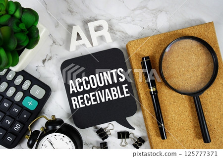 AR - Accounts Receivable acronym with calculator, alarm clock and magnifying glass, Business concept background AR - Accounts Receivable acronym with calculator, alarm clock and magnifying glass, Business concept background 125777371