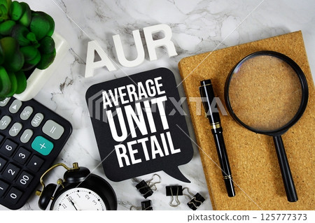 AUR  - Average Unit Retail acronym with calculator, alarm clock and magnifying glass, Business concept background 125777373