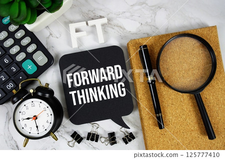 FT - Forward Thinking acronym with calculator, alarm clock and magnifying glass, business concept background 125777410