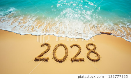 Year 2028 written in sand on a beautiful beach with waves gently lapping at the shore Year 2028 written in sand on a beautiful beach with waves gently lapping at the shore 125777535