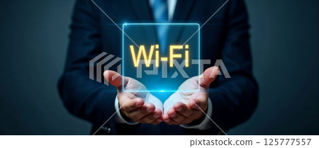 Business professional showcasing Wi-Fi technology in a modern digital environment with glowing holographic display Business professional showcasing Wi-Fi technology in a modern digital environment with glowing holographic display 125777557