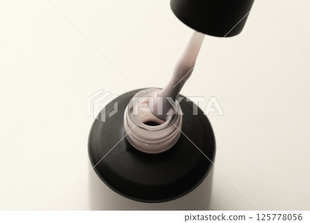 Soft Pink Gel Nail Polish Bottle with Brush on Light Soft Pink Gel Nail Polish Bottle with Brush on Light 125778056