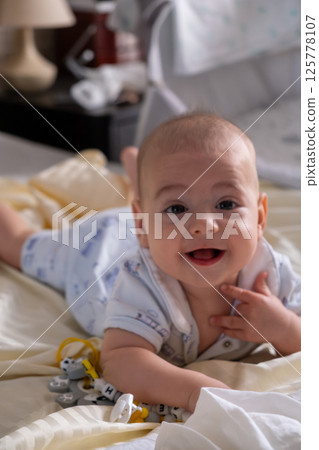 Happy Baby Playing with Toys on a Blanket 125778107