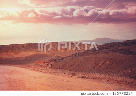 Mountain nature landscape. Desert in early morning. Beautiful sunrise in mountains. Judaean Desert. View of valley with mountains on backdrop. Nature Israel. Mountain nature landscape. Desert in early morning. Beautiful sunrise in mountains. Judaean Desert. View of valley with mountains on backdrop. Nature Israel. 125778234