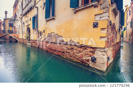 Venetian street in a rainy weather, Italy Europe Venetian street in a rainy weather, Italy Europe 125778296
