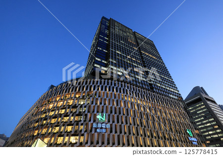 Hanshin Department Store and Osaka Umeda Station at dusk 125778415