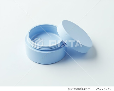 Blue cosmetic jar with lid open on a clean white surface showcasing its interior space for product storage 125778739