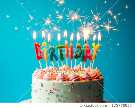 Colorful birthday cake with candles and sparklers creates a festive atmosphere for celebration Colorful birthday cake with candles and sparklers creates a festive atmosphere for celebration 125778933