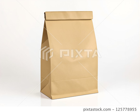 Brown paper bag with a fold-over top standing on a flat surface in a well-lit environment 125778955