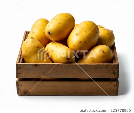 Fresh yellow potatoes arranged neatly in a wooden crate ready for culinary use or sale at a market setting 125778960