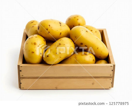Fresh yellow potatoes in a wooden crate showcasing natural imperfections and earthy texture Fresh yellow potatoes in a wooden crate showcasing natural imperfections and earthy texture 125778975