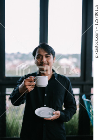 asian man having coffee in cafe 125780118