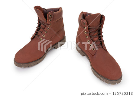 Brown leather boots. Pair of lace-up waterproof boots isolated on white background. Brown leather boots. Pair of lace-up waterproof boots isolated on white background. 125780318