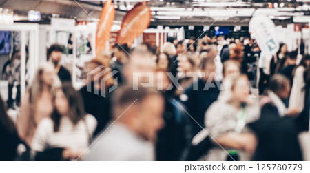 Abstract blurred people at exhibition hall of expo event trade show. Business convention show or job fair. Business concept background 125780779