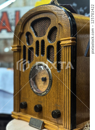 Close-Up of a Vintage Wooden Radio with Analog Dial 125781422