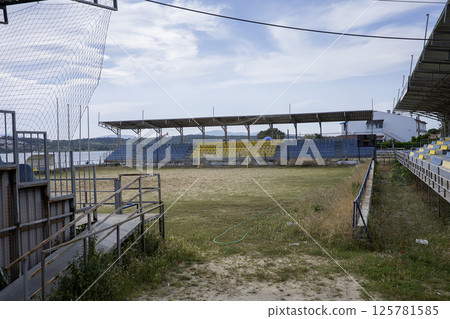 Abandoned stands of a football pitch on the beach 125781585