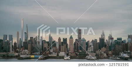 A blurry city skyline picture with a river in the foreground A blurry city skyline picture with a river in the foreground 125781591