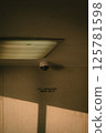 A security camera is strategically mounted on the ceiling of the building 125781598