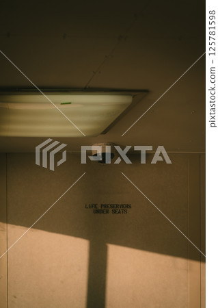 A security camera is strategically mounted on the ceiling of the building 125781598