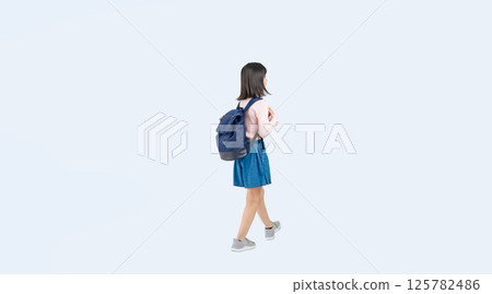 Full-body photo of an elementary school girl walking with a backpack 125782486