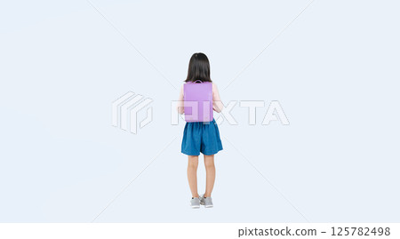Full-body photo of an elementary school girl wearing a backpack 125782498
