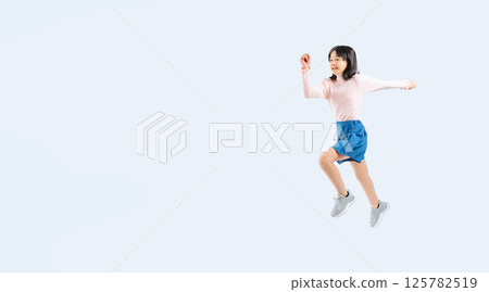 女孩奮力跳躍的全身照片 125782519
