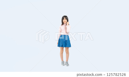 Full-body photo of a girl posing with her fist in the air 125782526