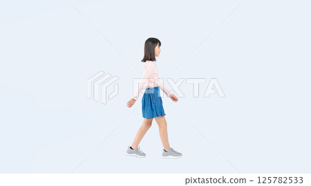 Full body photo of a girl walking sideways 125782533