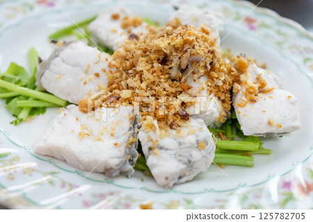 Top view of Steamed sea bass with dipping sauce, focus selective Top view of Steamed sea bass with dipping sauce, focus selective 125782705