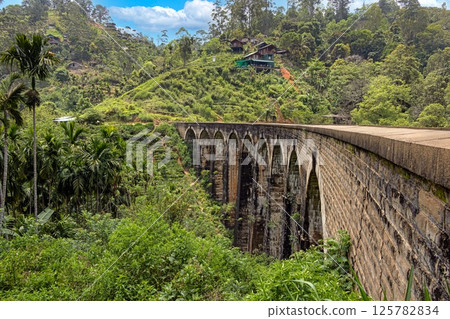 Historic Nine Arches Bridge in lush jungle near Ella, Sri Lanka, no people visible 125782834