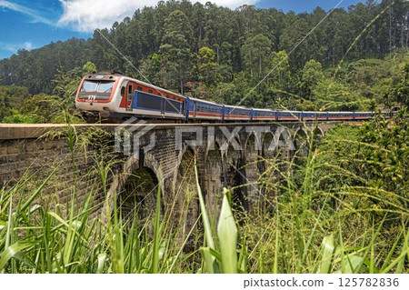 Historic Nine Arches Bridge in lush jungle near Ella, Sri Lanka, no people visible 125782836