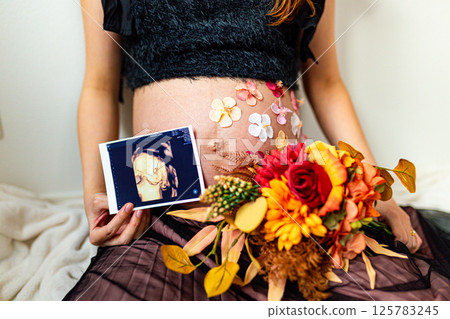 A woman having her maternity photo taken 125783245